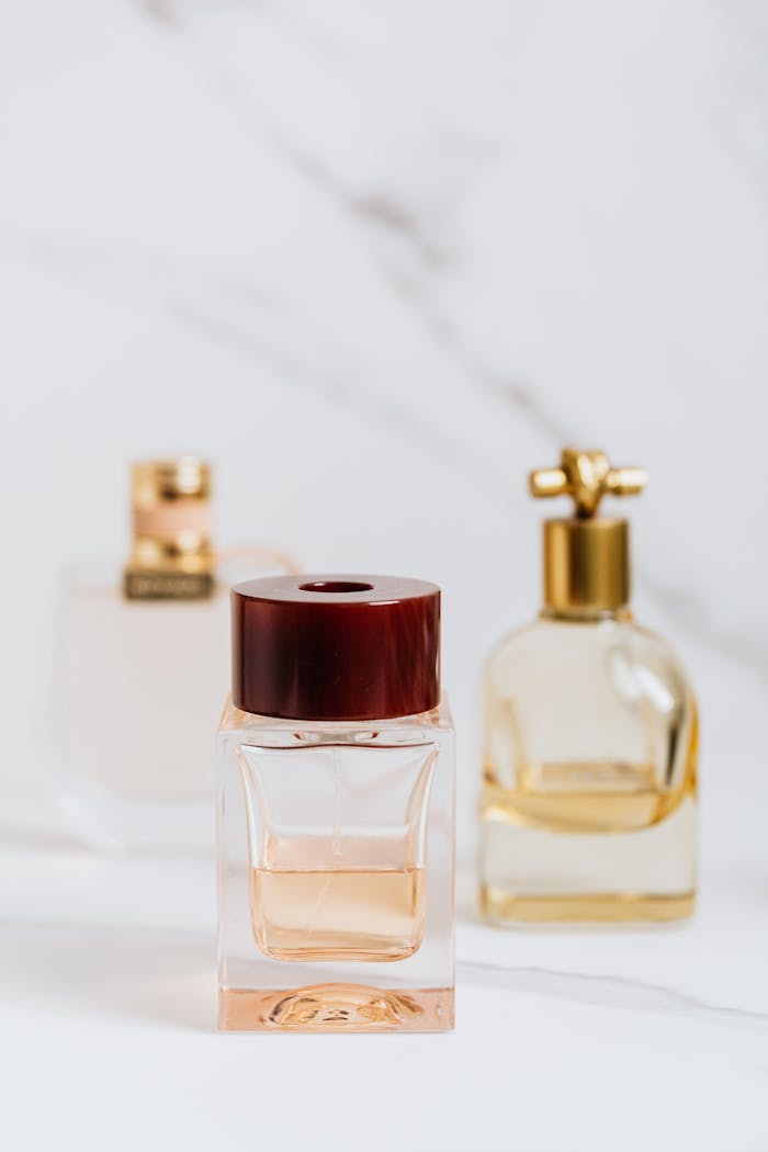 about-01 Elegant perfume bottles with gold accents on a stylish marble background.
